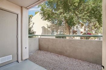 A view of a courtyard with a closed door. at The Viridian Apartments, Arizona